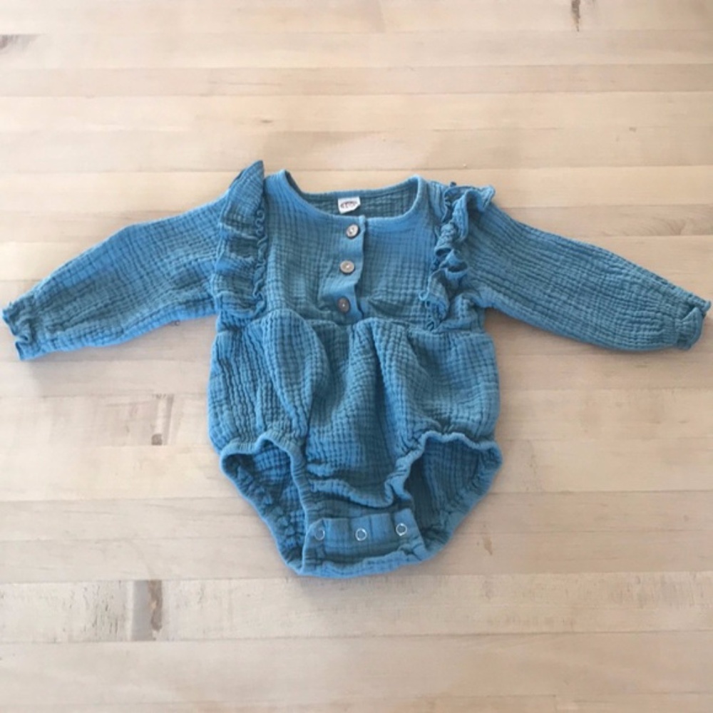 Adorable button front ruffle feature one piece.
